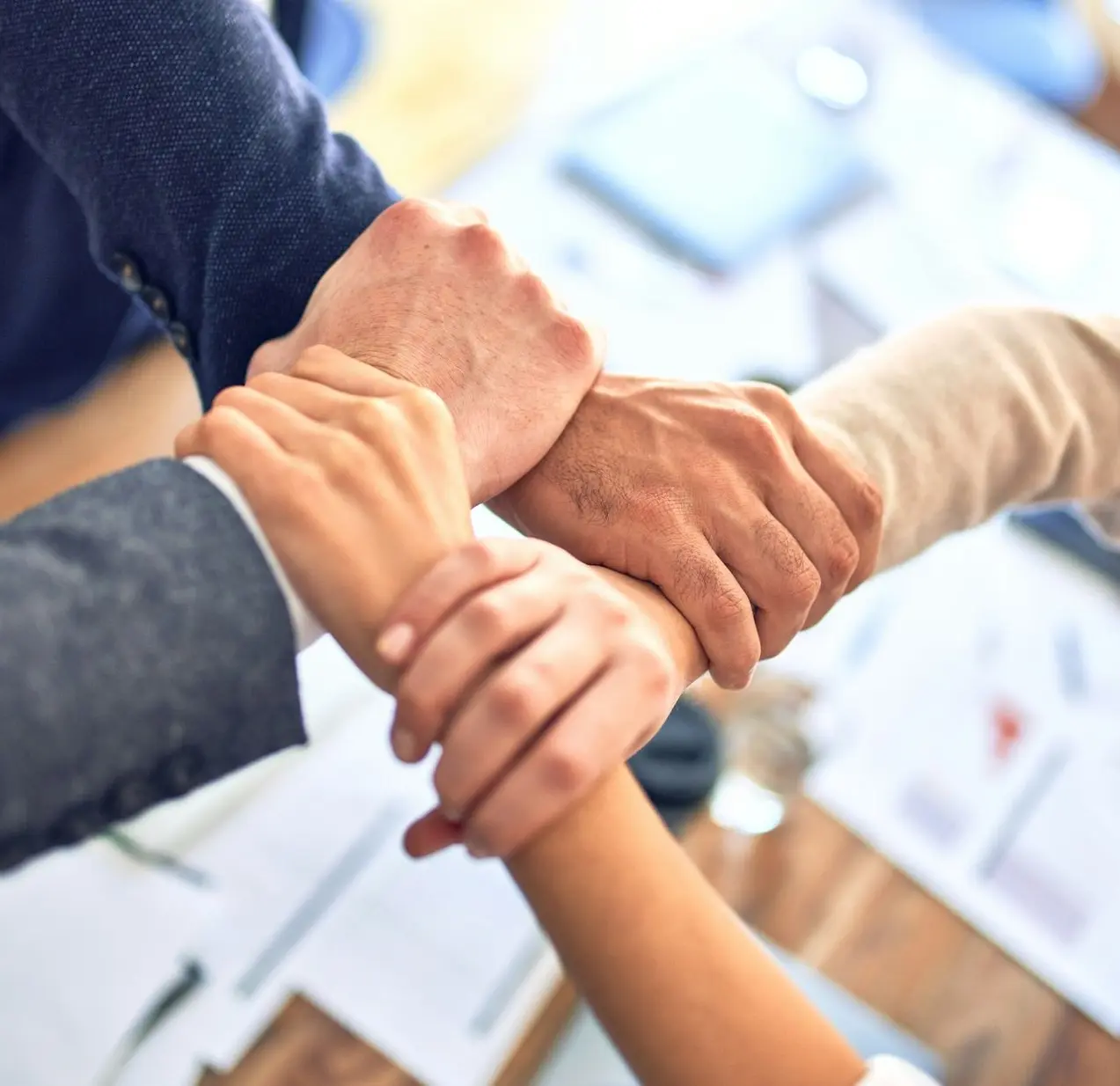 person in black long sleeve shirt holding persons hand
